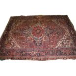 South East Persia carpet, the red field with a central stylised bird medallion and rows of