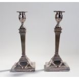 Pair of George III silver plated candlesticks, the urn top with ribbon swags and tapering columns on