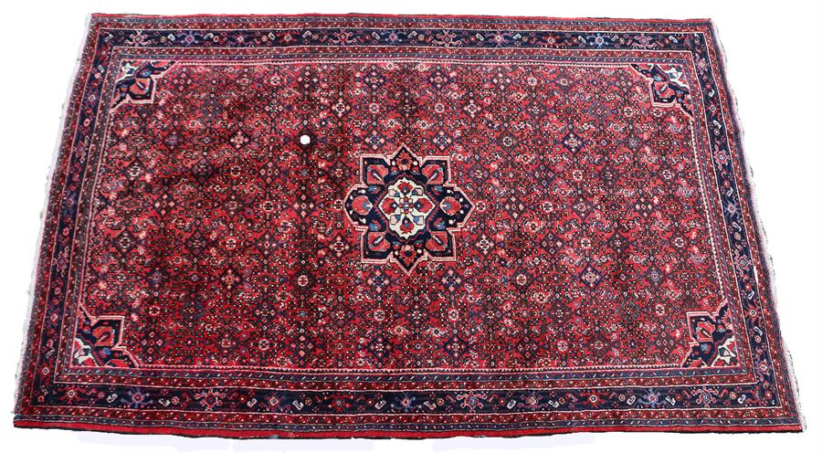 Hamadan rug, the red field with central blue medallion, the field with geometric panels and