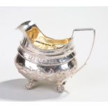 George III silver jug, London 1810, maker GB, with foliate decoration to the body with a silver gilt