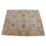 Pakistan carpet, the cream field with brick red foliate spandrels with a wide leaf edge border 365cm