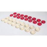 Set of Victorian Canton ivory carved draughts pieces, in natural and red with pieced carved