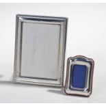 Two silver frames, the larger example London 1989 maker R. Carr Ltd, 12cm wide the smaller one