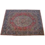 Persian carpet, the central cream medallion with flower decoration and multiple edge border, 366cm x