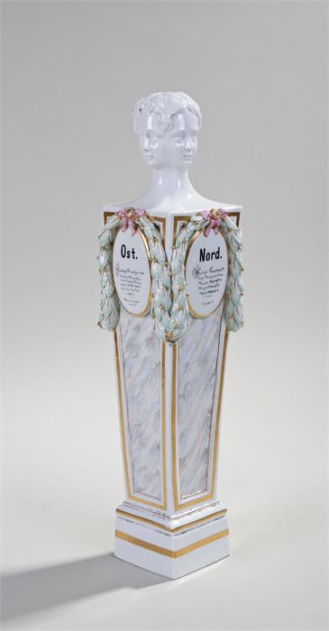 Meissen porcelain column, the column surmounted by a four portrait head above ribbon tied leaf