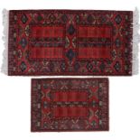 Two Indian Mossoul rugs, the first with central medallion of a red field with geometric border,