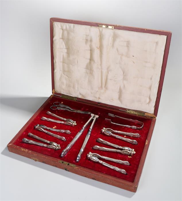 Impressive Victorian cased nut cracker set, with six nut crackers, a larger pair, grape scissors and