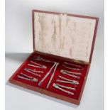 Impressive Victorian cased nut cracker set, with six nut crackers, a larger pair, grape scissors and