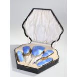 George V cased silver and guilloche enamel vanity set, Birmingham 1926, with a mirror and four