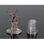 Novelty silver, to include a Dutch silver miniature windmill and an British silver thimble for