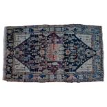 South West Persian rug, the central medallion with bands of purple and blue projecting with flowers,