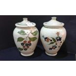 Two hand painted stoneware jars with lids, (2)