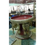 Decorative gilt centre table, the red dish top with gilt edge and elephant base, 75cm wide