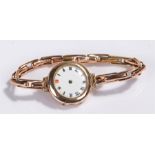 9 carat gold ladies wristwatch, the white enamel dial, manual wound, with 9 carat gold elasticated