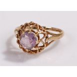 9 carat gold and amethyst set ring, the stone held above a fret head, ring size P