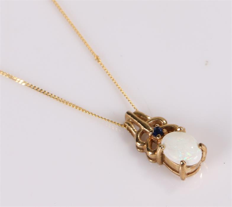 9 carat gold opal set pendant necklace, with a sapphire above the pearl