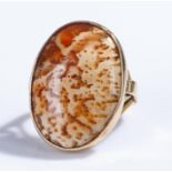 9 carat gold agate set ring, the oval agate with scroll band