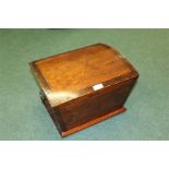 Domed pine box, the arched top above tapering sides and flanked by carrying handles, 35cm wide