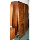 1920's figured walnut wardrobe, the arched doors enclosing storage and hanging space, 118cm wide