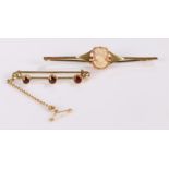 Brooches, to include a 9 carat gold cameo brooch and a garnet set brooch in yellow metal, (2)