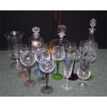 Three cut glass decanters together with some wine glasses, a vase and two stalls, with pad tops (