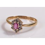 9 carat gold ring with central garnet flanked by further stones, ring size O