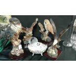 A collection of bird figures including eagles and owls,together with a Dresden china latticework