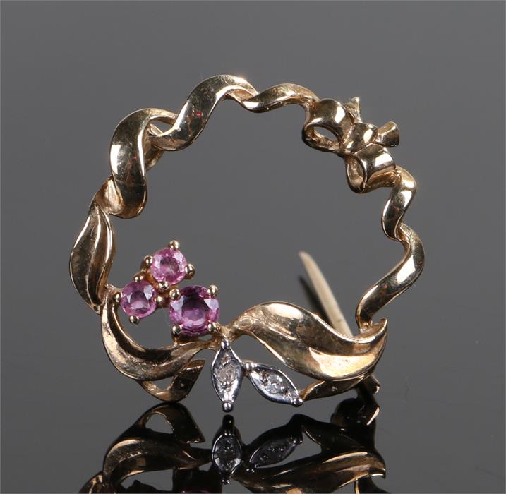 9 carat gold ruby and diamond brooch, the swag design with three rubies and two diamonds, 25mm