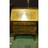 Early 20th Century walnut bureau, the sloping fall above three long drawers and cabriole legs