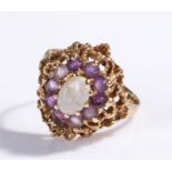 9 carat gold opal and amethyst set ring, the central oval opal with amethyst surround