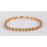 10 carat gold bracelet, set with pale green stones, 20cm long