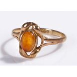 9 carat gold amber set ring, the oval amber held within leaf mounts