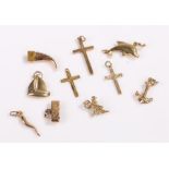 9 carat gold jewellery, mainly charms, together with three pendant crosses and a yellow metal claw