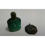 Bronze medallion, possibly 17th Century, together with a green snuff bottle, (2)