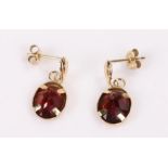 Pair of 9 carat gold earrings, set with garnets