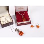 Amber jewellery, to include two pendant necklaces and a pair of heart shaped earrings, (4)