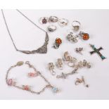 Silver jewellery, to include five silver rings, a silver stone set cross, charms to include