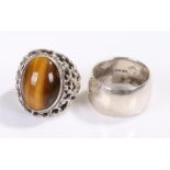 Silver tigers eye set ring, together with a wide silver band, total weight 26 grams