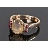 18 carat gold citrine and ruby set ring, the central citrine with ruby edge, ring size M 1/2