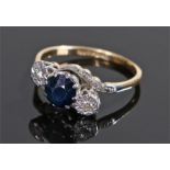 18 carat gold sapphire and diamond set ring, the central round cut sapphire flanked by diamonds,