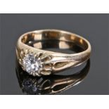 Yellow metal diamond solitaire ring, the round cut diamond at approximately 0.9 carat in size,