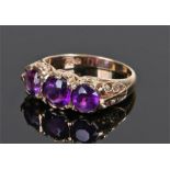 9 Carat amethyst ring, the head set with three round cut amethyst, ring size O