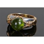 Fine Bulgari peridot ring, the central cabochon peridot at 9.9mm diameter approximately, flanked