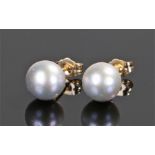 Pair of 18 carat gold pearl set earrings, with a single pearl to each, the pearls at 8mm diameter