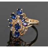 14 carat gold sapphire set ring, the sapphires set to the head to form a foliate design, ring size