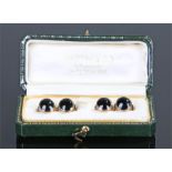 Cased set of 9 carat gold and enamel studs, the black enamel above the gold beam and disc, total