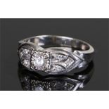 14 carat white gold diamond set ring, the central diamond flanked by three diamonds to either