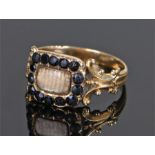 19 century mourning ring, with a black hardstone head and scroll shanks, ring size M