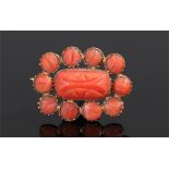 Victorian coral brooch, the central carved brooch with conforming carved coral surround, 25mm