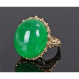 Jadeite set ring the large overall jadeite at 33.31 carat set to a yellow metal mount, ring size O